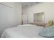 Bedroom with a closet, doorway, and a mirrored dresser at 7750 Ridgelake Cir, Bradenton, FL 34203