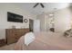 Relaxing bedroom featuring soft bedding, natural light, and glimpses of the ensuite bathroom and desk space at 7750 Ridgelake Cir, Bradenton, FL 34203