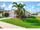 Charming single-story home with manicured lawn, lush landscaping, and a two-car garage at 7750 Ridgelake Cir, Bradenton, FL 34203