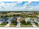 Well-manicured homes with lawns and landscaping near a serene pond at 7750 Ridgelake Cir, Bradenton, FL 34203