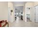 Bright foyer with tile flooring leads to a living room and bedroom, showcasing the home's layout at 7750 Ridgelake Cir, Bradenton, FL 34203