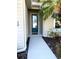 Close-up of front door with a decorative glass panel and neutral-colored exterior siding at 7750 Ridgelake Cir, Bradenton, FL 34203