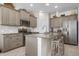 Open kitchen with stainless steel appliances, granite counters, an island with barstool seating, and ample cabinet space at 7750 Ridgelake Cir, Bradenton, FL 34203