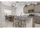 Modern kitchen featuring granite countertops, stainless steel appliances, and a breakfast bar with stylish wooden stools at 7750 Ridgelake Cir, Bradenton, FL 34203