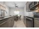 Cozy kitchen featuring a dining table with charming floral window treatment and stainless steel appliances at 7750 Ridgelake Cir, Bradenton, FL 34203