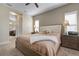 Beautiful main bedroom with a ceiling fan, bedside lamps, and an attached bathroom at 7750 Ridgelake Cir, Bradenton, FL 34203