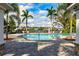 Community swimming pool with inviting blue water, palm trees, lounge chairs, and a nice outdoor area at 7750 Ridgelake Cir, Bradenton, FL 34203