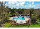Community pool with lounge chairs, covered seating, and palm trees at 7750 Ridgelake Cir, Bradenton, FL 34203