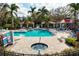 Community pool with spa and covered seating areas, offering ample space for relaxation and socializing at 7750 Ridgelake Cir, Bradenton, FL 34203