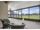 Cozy screened patio setup with comfortable wicker furniture and views of the outdoor space at 7750 Ridgelake Cir, Bradenton, FL 34203