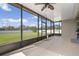 Spacious screened patio offering beautiful views of the backyard and clear skies at 7750 Ridgelake Cir, Bradenton, FL 34203