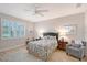 Cozy bedroom that features a neutral color scheme, a ceiling fan, and shuttered windows at 7983 Sandstar Way, Sarasota, FL 34240