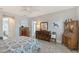 Comfortable bedroom featuring warm decor, wood-look flooring, and ample natural light at 7983 Sandstar Way, Sarasota, FL 34240