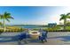 Community fire pit area with Adirondack chairs, perfect for enjoying evenings by the lake at 7983 Sandstar Way, Sarasota, FL 34240