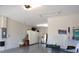 Spacious garage featuring ample storage cabinets, refrigerator, and epoxy flooring at 7983 Sandstar Way, Sarasota, FL 34240