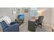 Cozy home office with a TV, comfortable chair, desk, and shuttered window at 7983 Sandstar Way, Sarasota, FL 34240