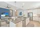 Contemporary kitchen showcasing sleek white cabinetry, stainless steel appliances, and a center island at 7983 Sandstar Way, Sarasota, FL 34240