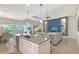 Open-concept kitchen that seamlessly flows into the living room with views of the pool at 7983 Sandstar Way, Sarasota, FL 34240