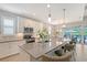 Well-appointed kitchen boasting a spacious island with bar seating and views of the outdoor area at 7983 Sandstar Way, Sarasota, FL 34240