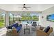 Relaxing screened lanai with comfortable wicker furniture overlooking a sparkling pool at 7983 Sandstar Way, Sarasota, FL 34240