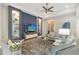 Comfortable living room area, accentuated by a striking blue accent wall and built-in shelving at 7983 Sandstar Way, Sarasota, FL 34240