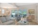 Inviting living area that offers views of the beautiful outdoor pool and patio area at 7983 Sandstar Way, Sarasota, FL 34240
