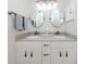 Bright bathroom featuring double sink vanity, and modern lighting at 821 Montrose Dr # 103, Venice, FL 34293