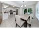 Bright dining area with granite counters, white cabinets, and stainless appliances at 821 Montrose Dr # 103, Venice, FL 34293