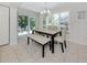 Cozy dining area with a stylish table, bench seating, and natural light at 821 Montrose Dr # 103, Venice, FL 34293