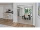 Dining area with a modern table set, adjacent to a bright, updated kitchen at 821 Montrose Dr # 103, Venice, FL 34293