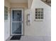 Close-up of a welcoming entrance featuring a decorated door, glass blocks, and ample lighting at 821 Montrose Dr # 103, Venice, FL 34293