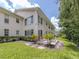 Rear exterior view of the home featuring a well-manicured lawn and patio at 821 Montrose Dr # 103, Venice, FL 34293