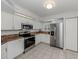 This kitchen offers stainless steel appliances, granite countertops and tiled floors at 821 Montrose Dr # 103, Venice, FL 34293