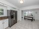 Bright eat-in kitchen featuring stainless steel refrigerator, and large window views to the exterior at 821 Montrose Dr # 103, Venice, FL 34293