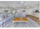 Bright living room with comfortable seating, ceiling fan, and an open layout at 821 Montrose Dr # 103, Venice, FL 34293