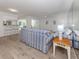 Bright living room with blue striped sofa, wood-look floors, and opening to the kitchen at 821 Montrose Dr # 103, Venice, FL 34293