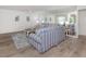 Bright living room with blue striped sofa, wood-look floors, and large wall mirror at 821 Montrose Dr # 103, Venice, FL 34293