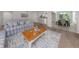 Open-concept living room features stylish furniture, wood floors, and access to dining at 821 Montrose Dr # 103, Venice, FL 34293