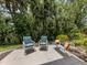 Outdoor patio with seating surrounded by tropical landscaping and shade at 821 Montrose Dr # 103, Venice, FL 34293