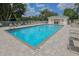 Community pool with a bathhouse in the background, with ample seating around at 821 Montrose Dr # 103, Venice, FL 34293