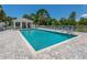 Sparkling community pool with ample seating and a cabana for relaxing at 821 Montrose Dr # 103, Venice, FL 34293