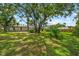 Expansive backyard with mature trees creating a private oasis with plenty of room at 8240 Cypress Lake Dr, Sarasota, FL 34243