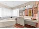 This bright bathroom has a soaking tub, glass shower and vanity with makeup area at 8240 Cypress Lake Dr, Sarasota, FL 34243