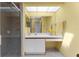 Bathroom with a skylight, bright yellow wall, and white cabinets at 8240 Cypress Lake Dr, Sarasota, FL 34243