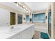 Bright bathroom featuring a double vanity, tile flooring, and a combined shower and bathtub at 8240 Cypress Lake Dr, Sarasota, FL 34243