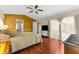 Bright and inviting bedroom boasts wood flooring, ceiling fan, and ensuite bathroom at 8240 Cypress Lake Dr, Sarasota, FL 34243