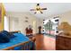 Cozy bedroom with wood floors, ceiling fan, and sliding glass doors to the pool area at 8240 Cypress Lake Dr, Sarasota, FL 34243