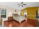 This sunny bedroom is equipped with a ceiling fan, wood floors, and bright windows at 8240 Cypress Lake Dr, Sarasota, FL 34243