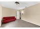 Bedroom with neutral walls, carpeting, and a comfortable red sofa at 8240 Cypress Lake Dr, Sarasota, FL 34243