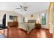 Well-lit bedroom with wood floors, neutral walls, and a large window at 8240 Cypress Lake Dr, Sarasota, FL 34243